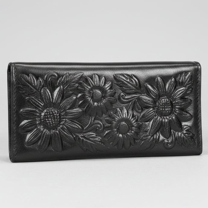 Black leather wallet with floral embossing on a white background
