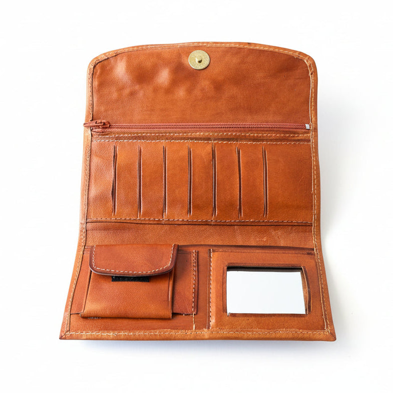 Brown leather wallet with multiple card slots on a light gray surface