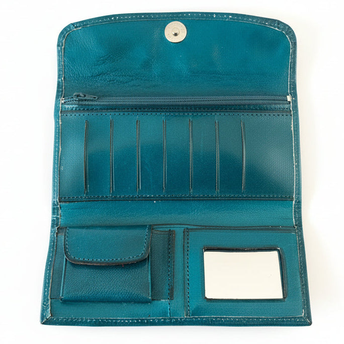 Teal wallet with multiple compartments on a wooden surface