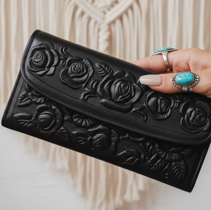 Brown leather wallet with floral embossing on a white background